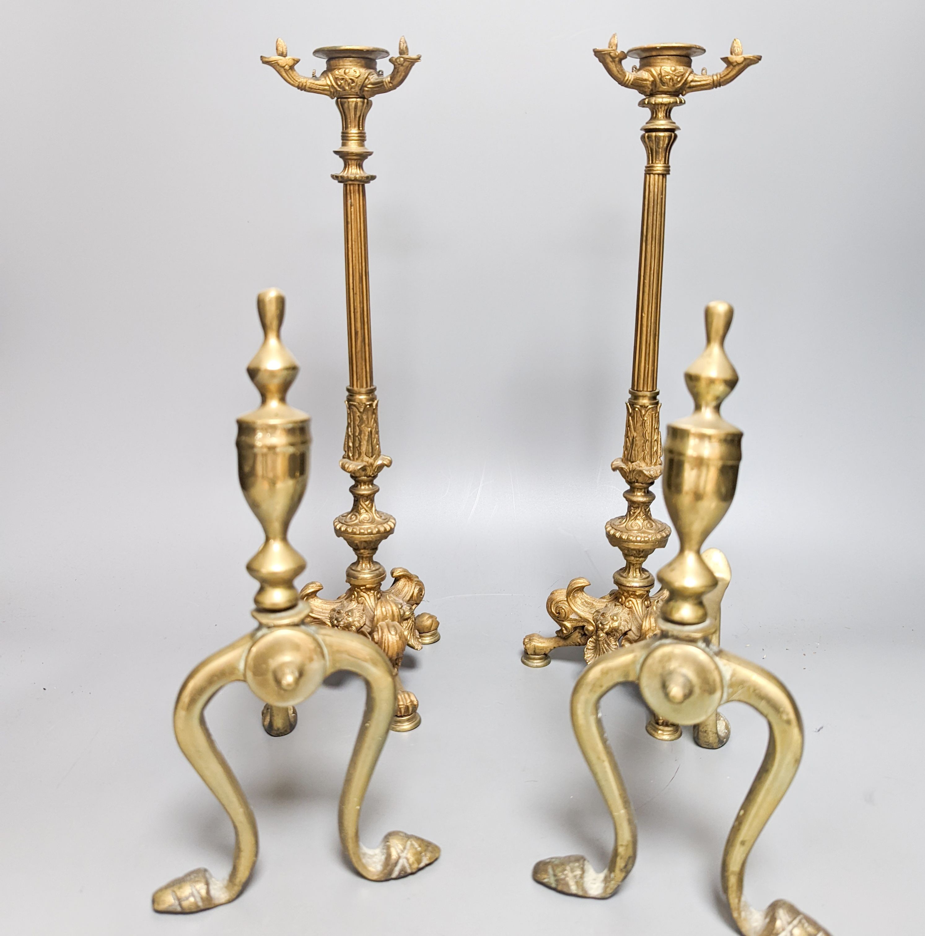 A pair of Empire style ormolu candlesticks and a pair of fire irons tallest 36cm